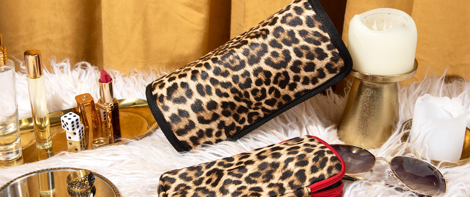 Image of leopard print Miamica Mob Wife Collection jewelry roll and double sided glasses case with other decorated gold items