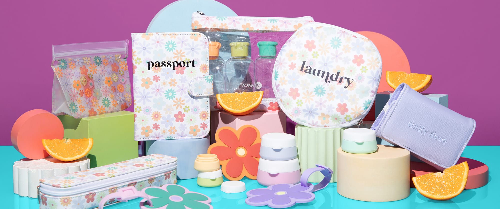 Image of Tangerine Crush travel accessories featuring colorful daisy print patterns in muted pastels.