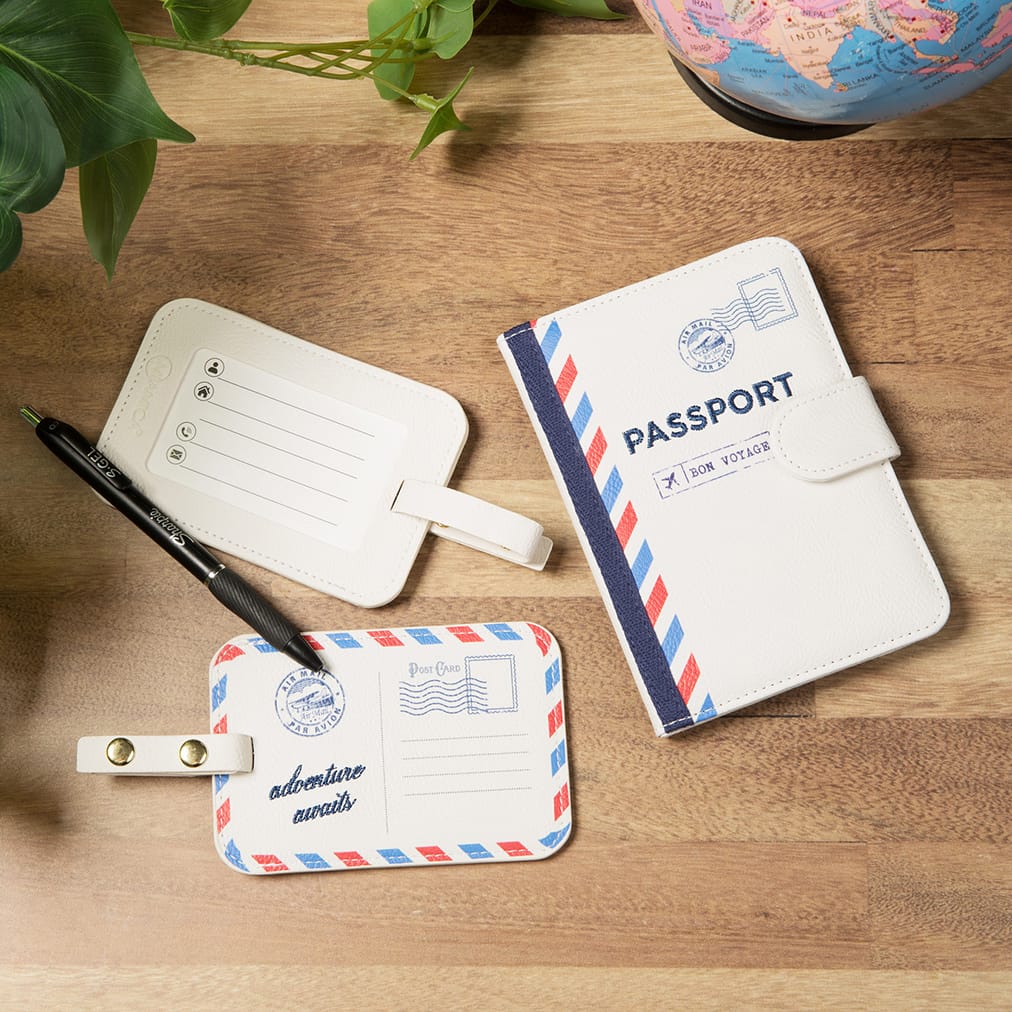 View of 2PC See the World ivory luggage tags and Passport Case. The items feature a vintage air mail postage design in red, white & blue.